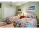 Comfortable bedroom featuring twin beds with vibrant floral bedding and neutral carpet at 19115 E Buckskin Ct, Rio Verde, AZ 85263