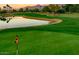 Scenic golf course view showcasing lush green fairways, a pond, and mountain views at 19115 E Buckskin Ct, Rio Verde, AZ 85263