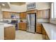 Bright kitchen featuring stainless steel appliances, light wood cabinets, and ample counter space at 19115 E Buckskin Ct, Rio Verde, AZ 85263