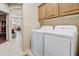 Convenient laundry area featuring a washer, dryer, and storage cabinets at 19115 E Buckskin Ct, Rio Verde, AZ 85263