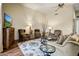 Comfortable living room featuring stylish furniture, wood floors, and a ceiling fan at 19115 E Buckskin Ct, Rio Verde, AZ 85263