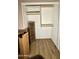 Walk in closet with wooden laminate floors and ample shelf space for storage at 19976 N 63Rd Dr, Glendale, AZ 85308
