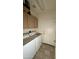 Laundry room featuring a washer, dryer and overhead cabinets for storage at 19976 N 63Rd Dr, Glendale, AZ 85308