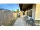 Covered patio with seating area, adjacent to a block wall and manicured landscape at 19976 N 63Rd Dr, Glendale, AZ 85308