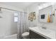 Cozy bathroom features a shower-tub combo with white tiling and a gray vanity at 2039 N 12Th St, Phoenix, AZ 85006