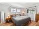 Comfortable bedroom with neutral tones, wood accents, and ample natural light from multiple windows at 2039 N 12Th St, Phoenix, AZ 85006