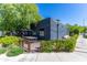 Commercial building with a black exterior, greenery, and outdoor seating at 2039 N 12Th St, Phoenix, AZ 85006
