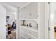 Hallway with built-in white cabinets and drawers, provides ample storage space at 2039 N 12Th St, Phoenix, AZ 85006