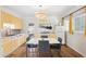 Bright kitchen with stainless steel appliances, yellow cabinets, hardwood floors, and eat-in dining at 2039 N 12Th St, Phoenix, AZ 85006