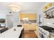 Well-lit kitchen features yellow cabinetry, stainless steel appliances, and an adjacent dining area at 2039 N 12Th St, Phoenix, AZ 85006