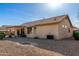 The backyard has desert landscaping, covered patio, tan exterior, and tile roof at 20717 N 104Th Ln, Peoria, AZ 85382