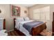 Cozy bedroom with a wood-frame bed, a plush grey blanket, and a bright window at 20717 N 104Th Ln, Peoria, AZ 85382