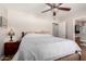 Bright bedroom featuring a decorative ceiling fan, closet and an ensuite bath at 20717 N 104Th Ln, Peoria, AZ 85382