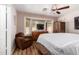 Comfortable bedroom with bay window, ceiling fan, and a cozy armchair at 20717 N 104Th Ln, Peoria, AZ 85382