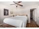 Bright bedroom featuring a decorative ceiling fan, closet and an ensuite bath at 20717 N 104Th Ln, Peoria, AZ 85382