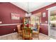 Dining room features a decorative chandelier, colorful accents, and a sliding glass door to the backyard at 20717 N 104Th Ln, Peoria, AZ 85382