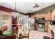 Eat-in kitchen with stainless steel appliances, a glass-top dining table, and plenty of natural light at 20717 N 104Th Ln, Peoria, AZ 85382