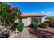Inviting home exterior with tiled roof, manicured shrubs, and a walkway leading to a charming front door at 20717 N 104Th Ln, Peoria, AZ 85382