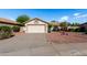Charming single-story home featuring a well-maintained yard and a neutral-toned exterior with a two-car garage at 20717 N 104Th Ln, Peoria, AZ 85382