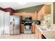 Well-lit kitchen featuring stainless steel appliances and tiled floors with ample counter space at 20717 N 104Th Ln, Peoria, AZ 85382