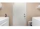 The laundry room contains a washer, dryer, utility door, and shelves at 20717 N 104Th Ln, Peoria, AZ 85382