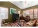 Cozy living room with warm colors, comfortable seating, and natural light streaming through the windows at 20717 N 104Th Ln, Peoria, AZ 85382