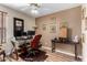 This office features a glass desk, rolling chair, decor, and neutral walls at 20717 N 104Th Ln, Peoria, AZ 85382