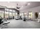 Bright community gym with various machines, weights, and plenty of natural light and ceiling fan at 20801 N 90Th Pl # 210, Scottsdale, AZ 85255