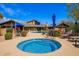 Inviting community hot tub area with ample seating and lush desert landscaping at 20801 N 90Th Pl # 210, Scottsdale, AZ 85255