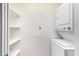 Laundry room with stacked washer and dryer and shelving for organized storage at 20801 N 90Th Pl # 210, Scottsdale, AZ 85255