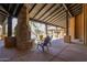 Outdoor lounge with stone fireplace, comfortable seating and view of the community pool at 20801 N 90Th Pl # 210, Scottsdale, AZ 85255
