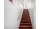 A modern staircase with sleek metal railing ascends alongside a bright white wall at 20801 N 90Th Pl # 210, Scottsdale, AZ 85255