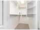 Walk-in closet with a carpeted floor and multiple storage shelves at 20801 N 90Th Pl # 210, Scottsdale, AZ 85255