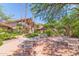 Charming courtyard with tables, chairs, shade trees, and lush desert landscaping at 2233 E Behrend Dr # 211, Phoenix, AZ 85024
