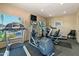 Well-equipped gym with cardio machines, TV, and natural light from a window at 2233 E Behrend Dr # 211, Phoenix, AZ 85024