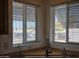 Bright kitchen view showcases the sink, two windows, and desert landscaping at 2233 E Behrend Dr # 211, Phoenix, AZ 85024