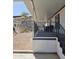 A covered patio with stairs leading down to a gravel yard area at 2233 E Behrend Dr # 211, Phoenix, AZ 85024