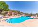 Beautifully landscaped pool area with waterfall feature and desert mountain views under clear blue sky at 2233 E Behrend Dr # 211, Phoenix, AZ 85024