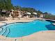 Sparkling pool with waterfall and seating under a clear sky in a desert landscape at 2233 E Behrend Dr # 211, Phoenix, AZ 85024