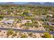 Expansive desert-landscaped property featuring mature trees, pool, putting green, mountains, and a neighboring golf course at 22469 N 79Th Pl, Scottsdale, AZ 85255