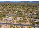 Desert-landscaped property featuring mature trees, pools, putting green, and a neighboring golf course, with mountains in view at 22469 N 79Th Pl, Scottsdale, AZ 85255