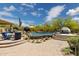 Expansive outdoor living space with a large pool, fire pit, kitchen and manicured landscaping at 22469 N 79Th Pl, Scottsdale, AZ 85255