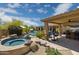 Resort-style backyard showcasing a pool, spa, and covered patio with outdoor kitchen area at 22469 N 79Th Pl, Scottsdale, AZ 85255