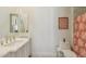 Bright bathroom featuring white vanity, marble countertops, and coral patterned shower curtain at 22469 N 79Th Pl, Scottsdale, AZ 85255