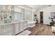 Bright bathroom features dual sinks, a soaking tub under a chandelier, and wood flooring at 22469 N 79Th Pl, Scottsdale, AZ 85255