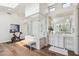 Bright bathroom offers a glass walk-in shower and and vanities with wood-style flooring at 22469 N 79Th Pl, Scottsdale, AZ 85255