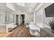 Bright bathroom featuring a chandelier, freestanding tub and a large glass block window at 22469 N 79Th Pl, Scottsdale, AZ 85255