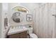 Bright bathroom with decorative mirror, natural wood vanity, and patterned tile shower at 22469 N 79Th Pl, Scottsdale, AZ 85255