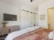 Modern bedroom with neutral decor, ceiling fan, TV, dresser, and closet at 22469 N 79Th Pl, Scottsdale, AZ 85255