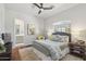 Comfortable bedroom with hardwood floors, ceiling fan, and ensuite bathroom at 22469 N 79Th Pl, Scottsdale, AZ 85255